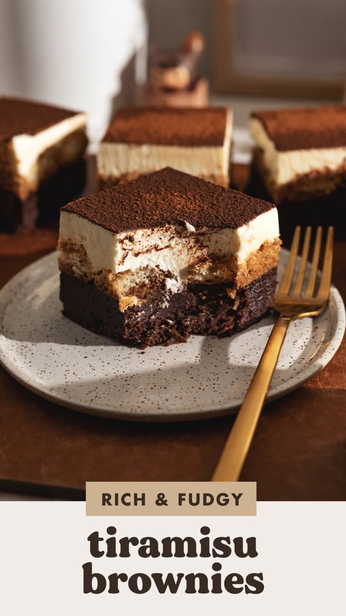 A tiramisu brownie on a plate with a bite taken out of it.