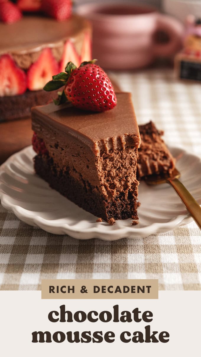 A slice of chocolate mousse cake with a forkful taken out of it to show the texture inside.