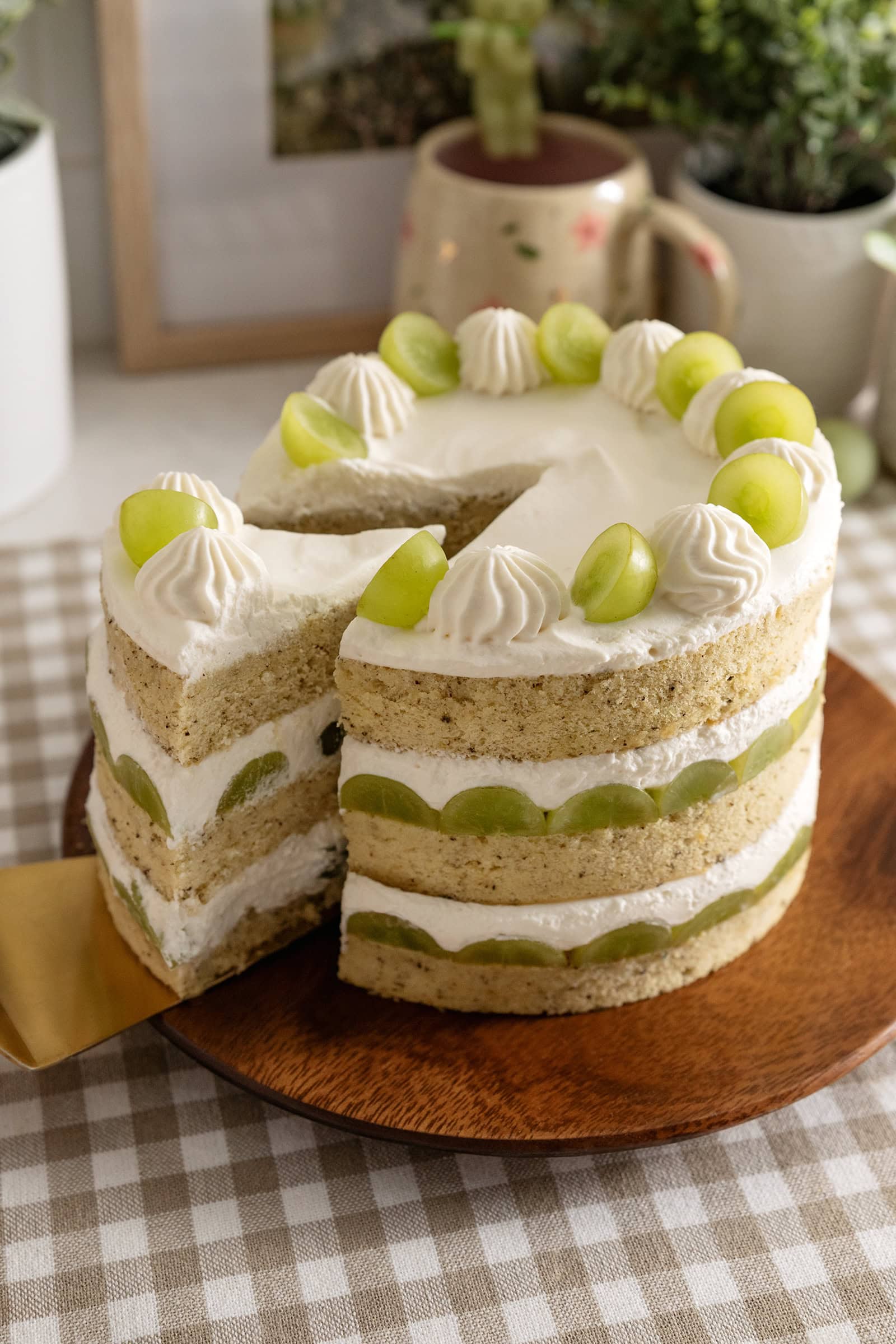 Pulling a slice of cake out of a jasmine green grape cake.