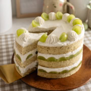 Pulling a slice of cake out of a jasmine green grape cake.