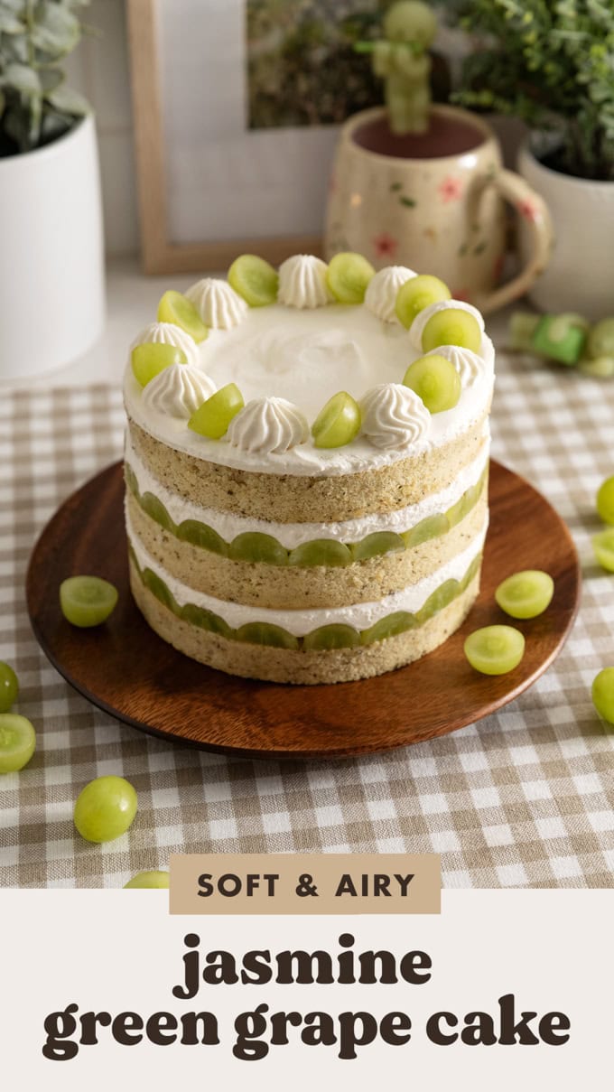 A jasmine green grape cake with all the layers visible on the outside on a wooden plate.