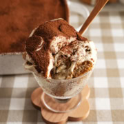 A glass serving cup filled with banana pudding tiramisu.