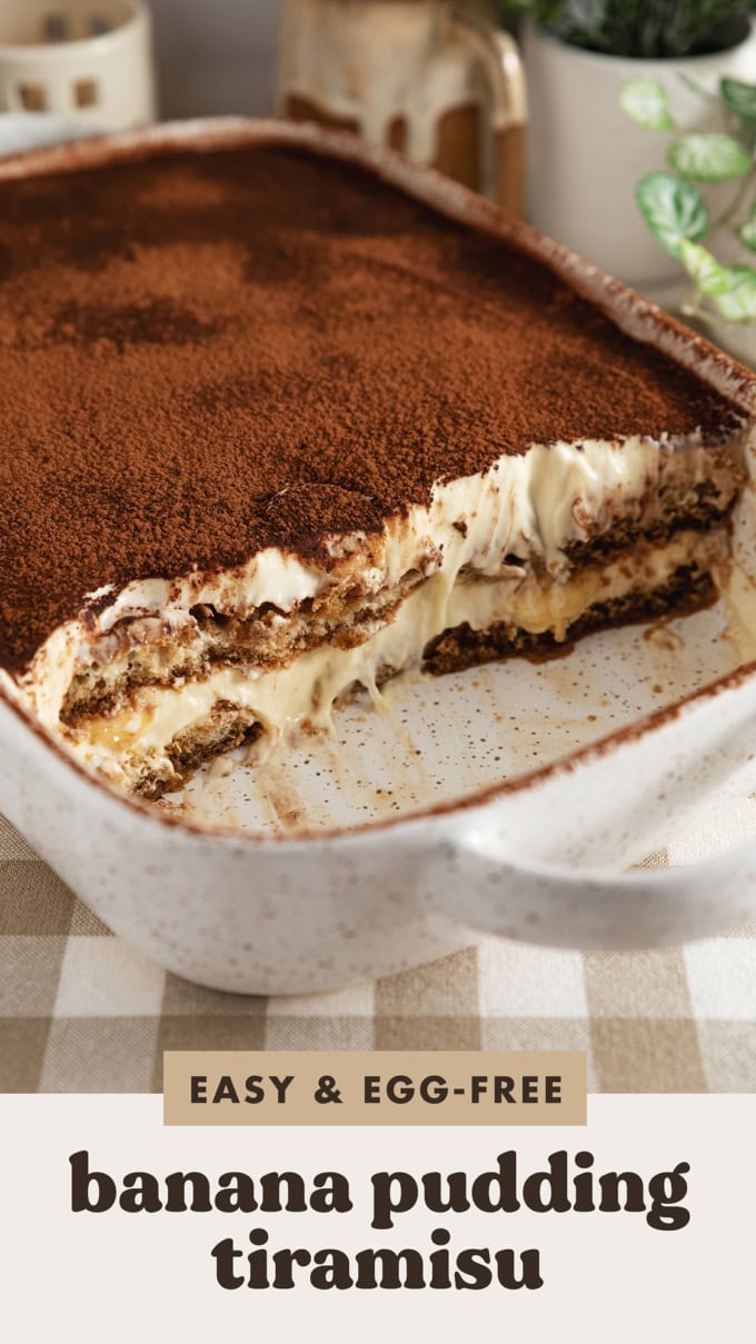 A dish of banana pudding tiramisu with a quarter of it scooped out to show the layers inside.