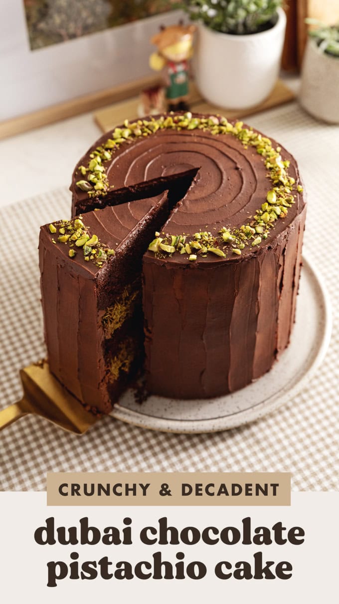 A Dubai chocolate pistachio cake with a slice cut out and slightly pulled out.