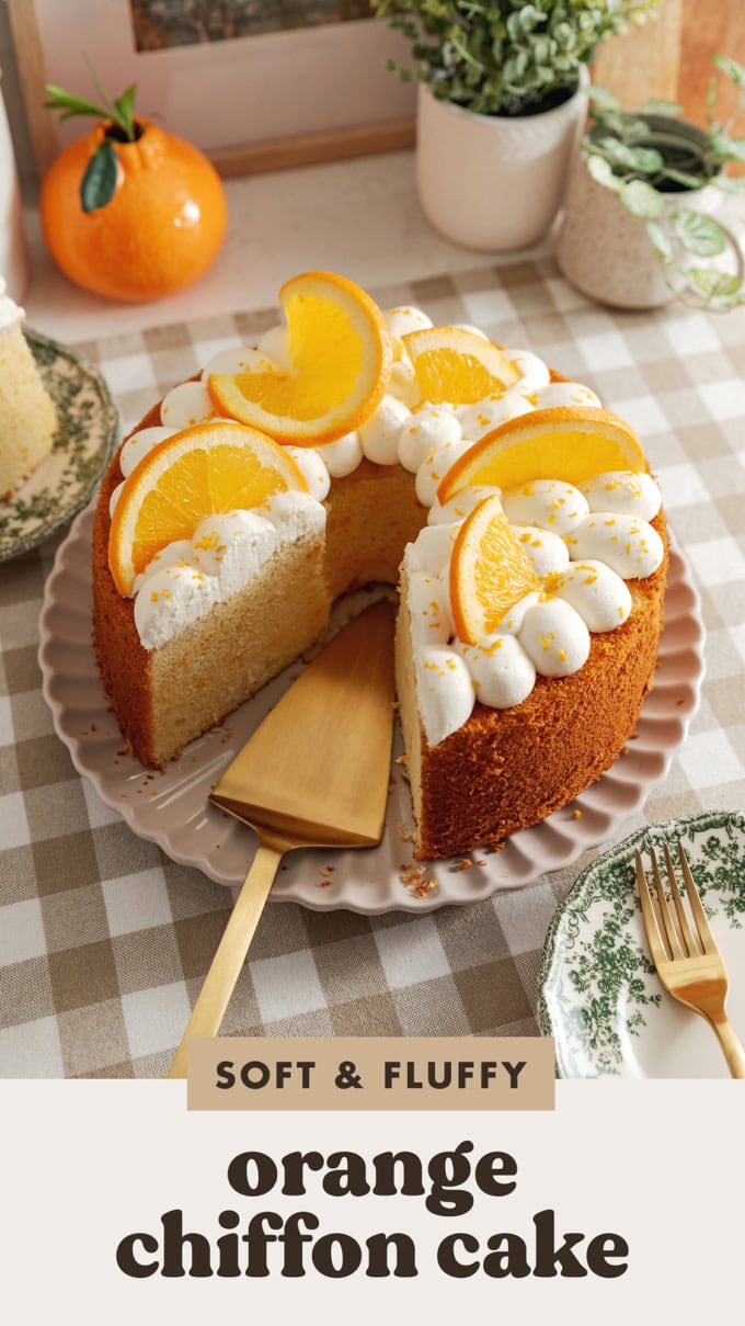 An orange chiffon cake on a plate with a cake server where a slice was removed.