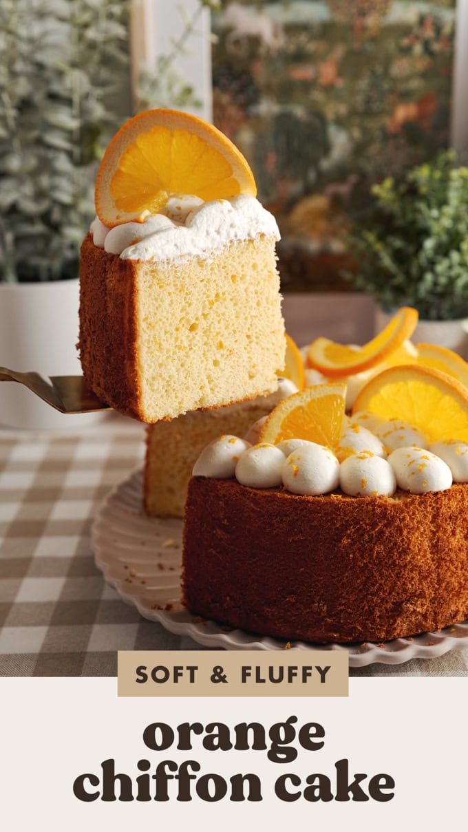 Lifting a slice of orange chiffon cake with a cake server above the rest of the cake.