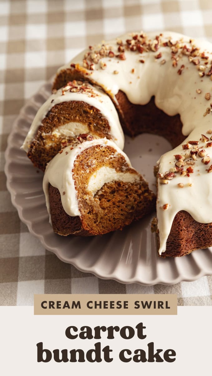Two slices of carrot bundt cake leaning against each other next to the rest of the cake.