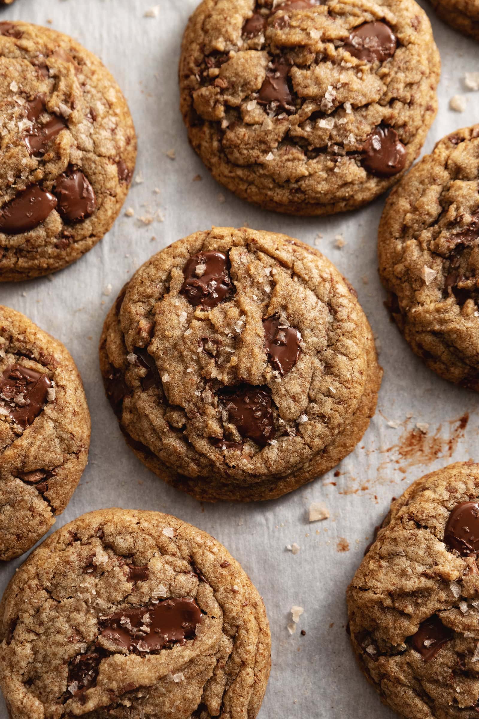 Espresso chocolate chip cookies scattered on parchment paper.