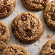 Espresso chocolate chip cookies scattered on parchment paper.