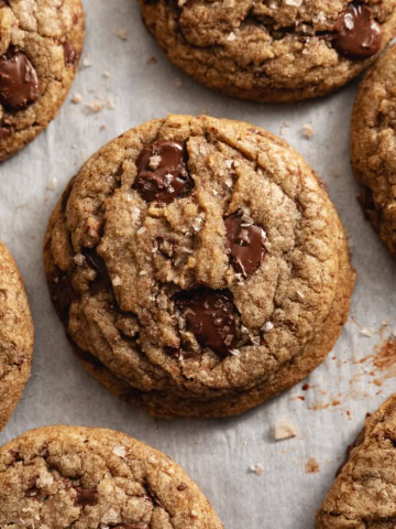 Espresso chocolate chip cookies scattered on parchment paper.