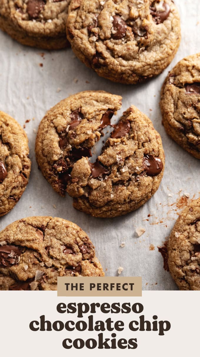 An espresso chocolate chip cookie split in half and slightly pulled apart to show the gooey melted chocolate.