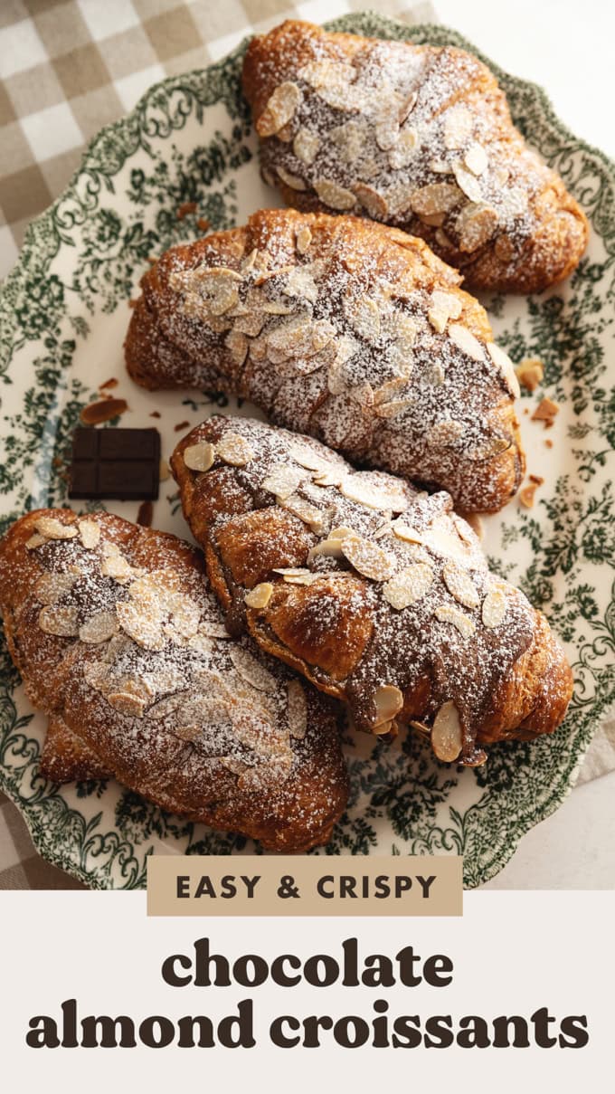 Four chocolate almond croissants on a green vintage serving plate.