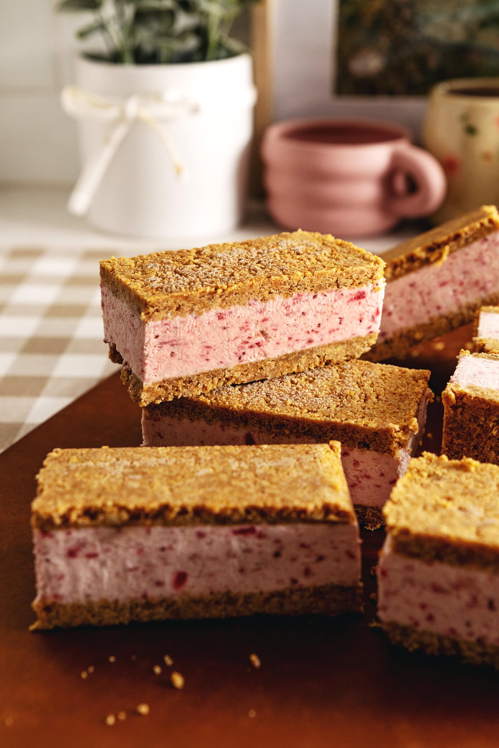 Strawberry ice cream sandwiches stacked on top of one another.