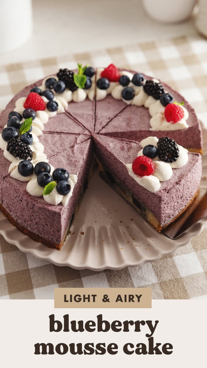 A blueberry mousse cake cut into slices on a plate.