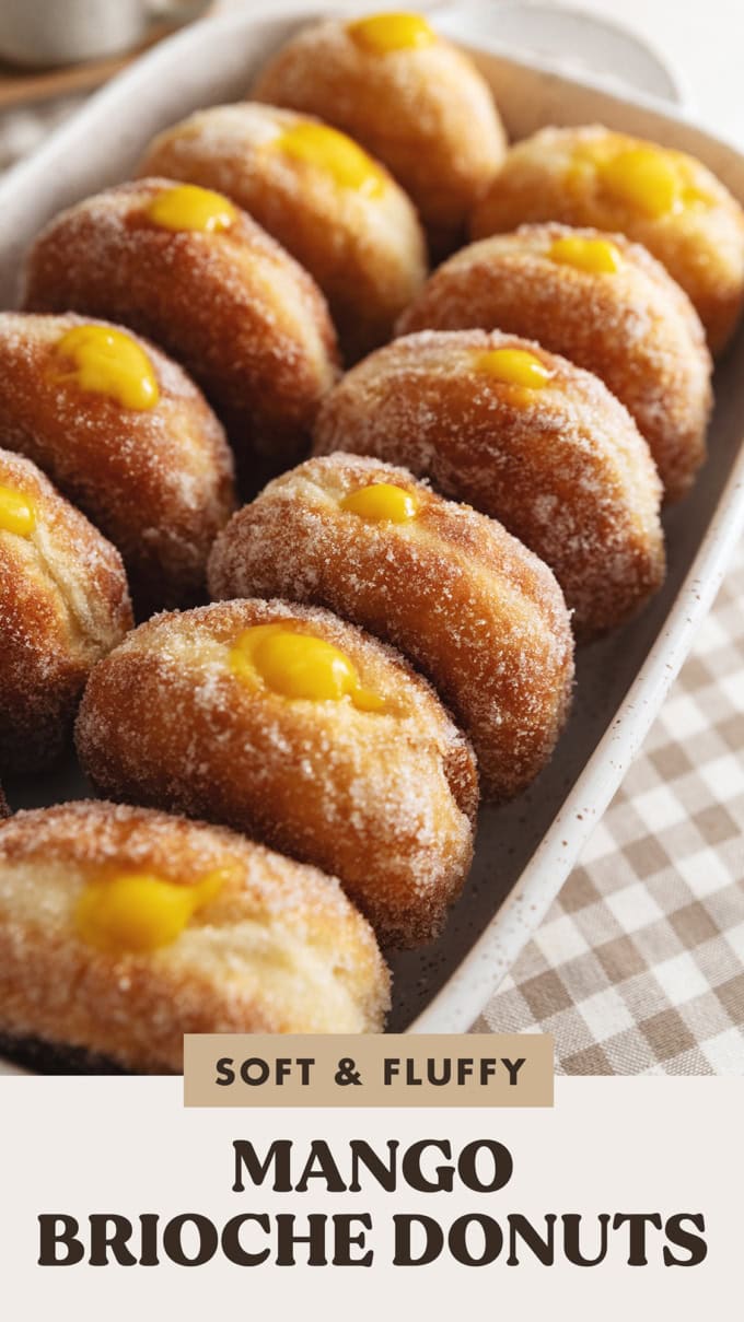 Several mango brioche donuts lined up in a baking dish.