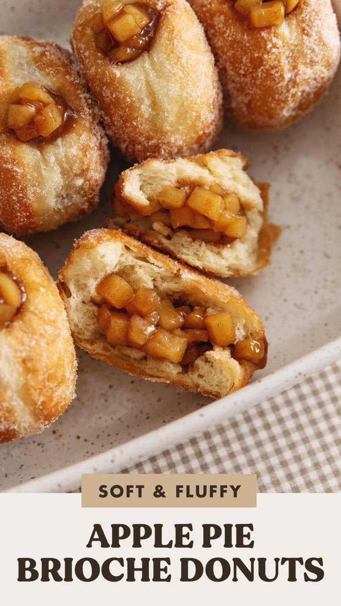 An apple pie donut ripped in half to show the apple pie filling inside.