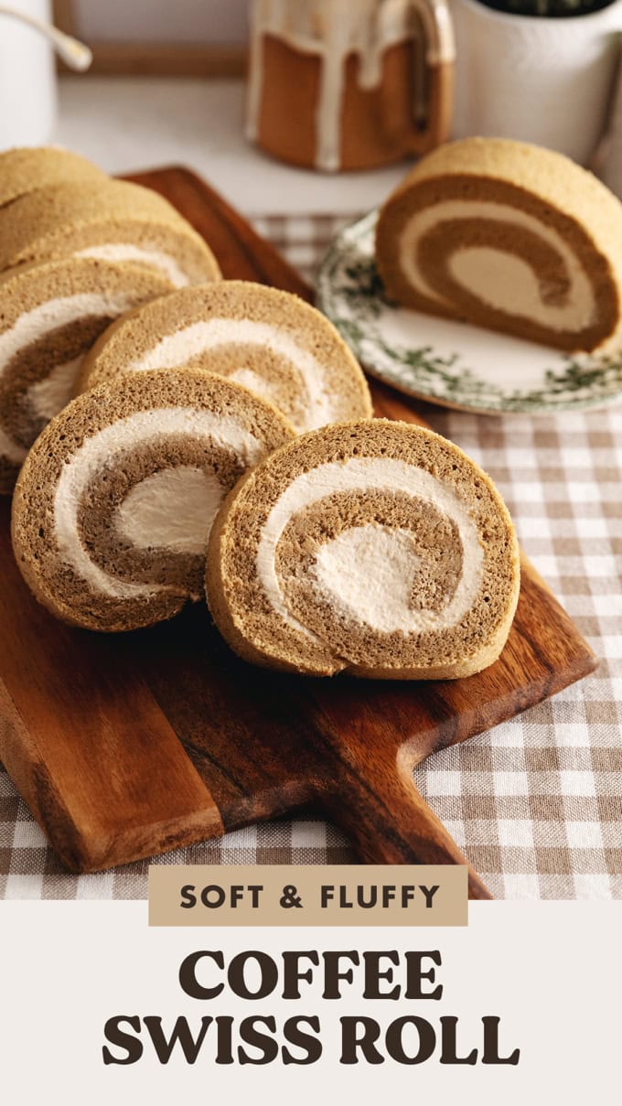 Several slices of a coffee swiss roll leaning against each other on a wooden board.