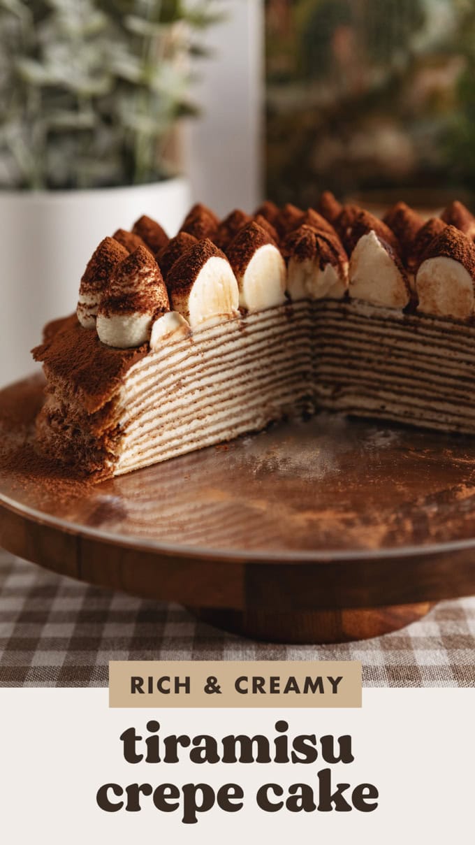 A cut cross section of a tiramisu crepe cake showing the layers of crepes and mascarpone cream inside.