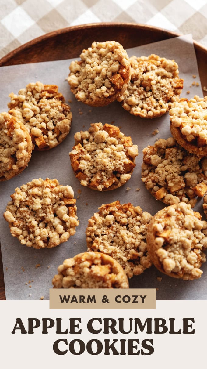 Apple crumble cookies scattered on a wooden platter.