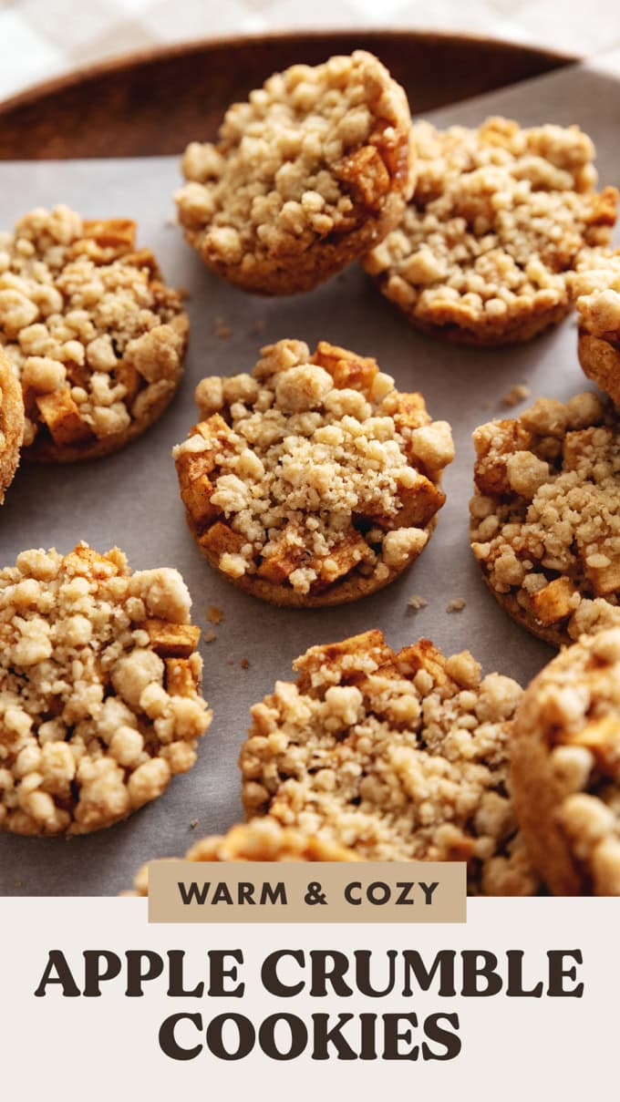 Close-up of apple crumble cookies scattered on a wooden tray.