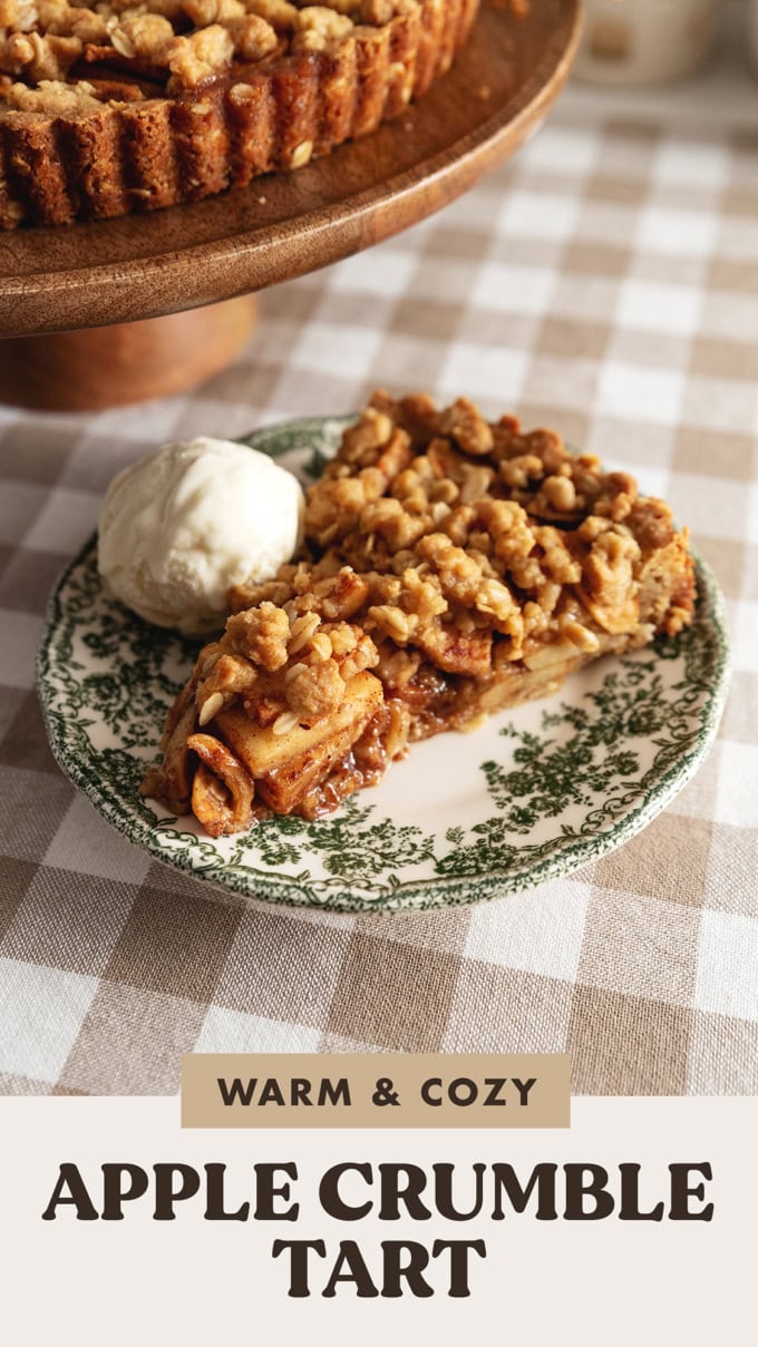 A slice of apple crumble tart and a scoop of ice cream on a vintage plate.