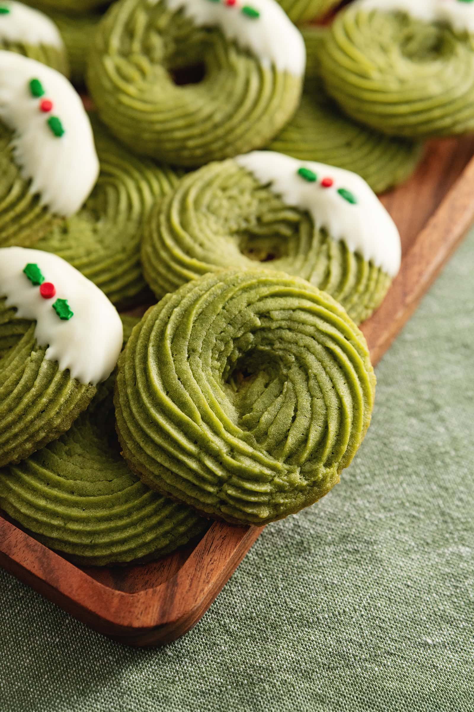 Close up of a matcha butter cookie piped into a swirl.