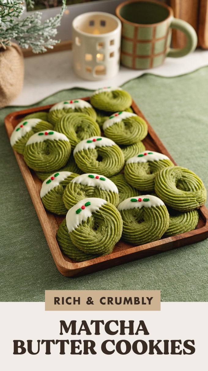 A tray of matcha butter cookies decorated with Christmas sprinkles on a kitchen counter.
