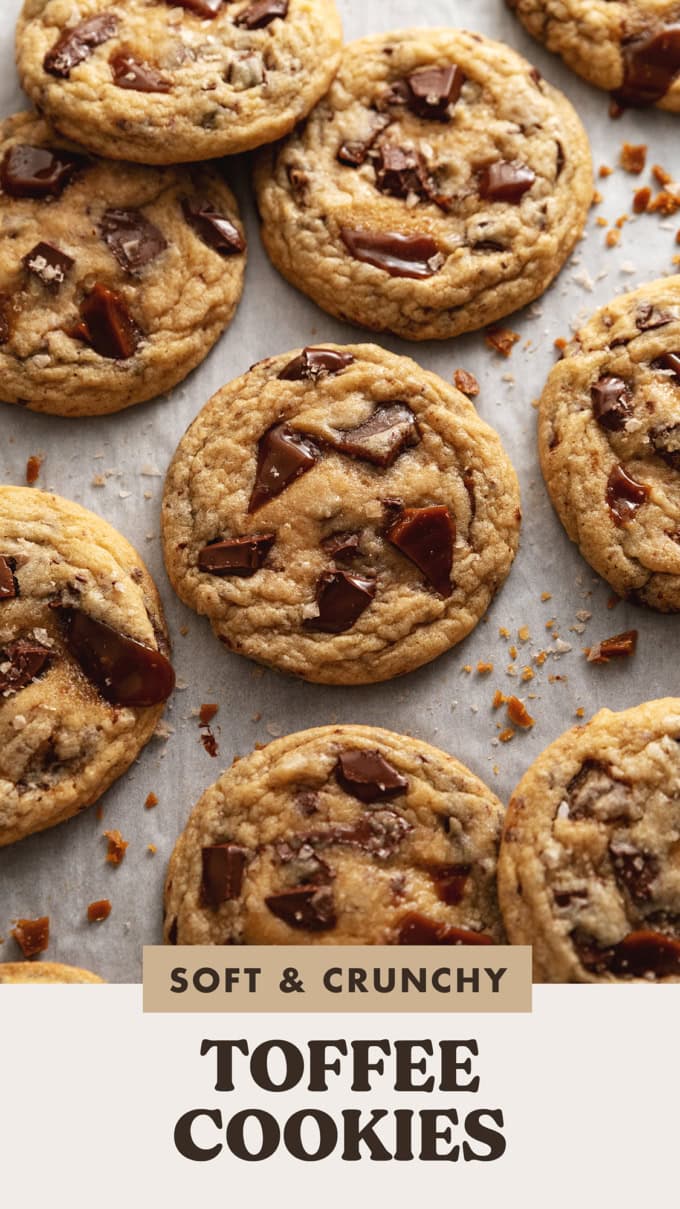 Toffee cookies scattered on parchment paper.