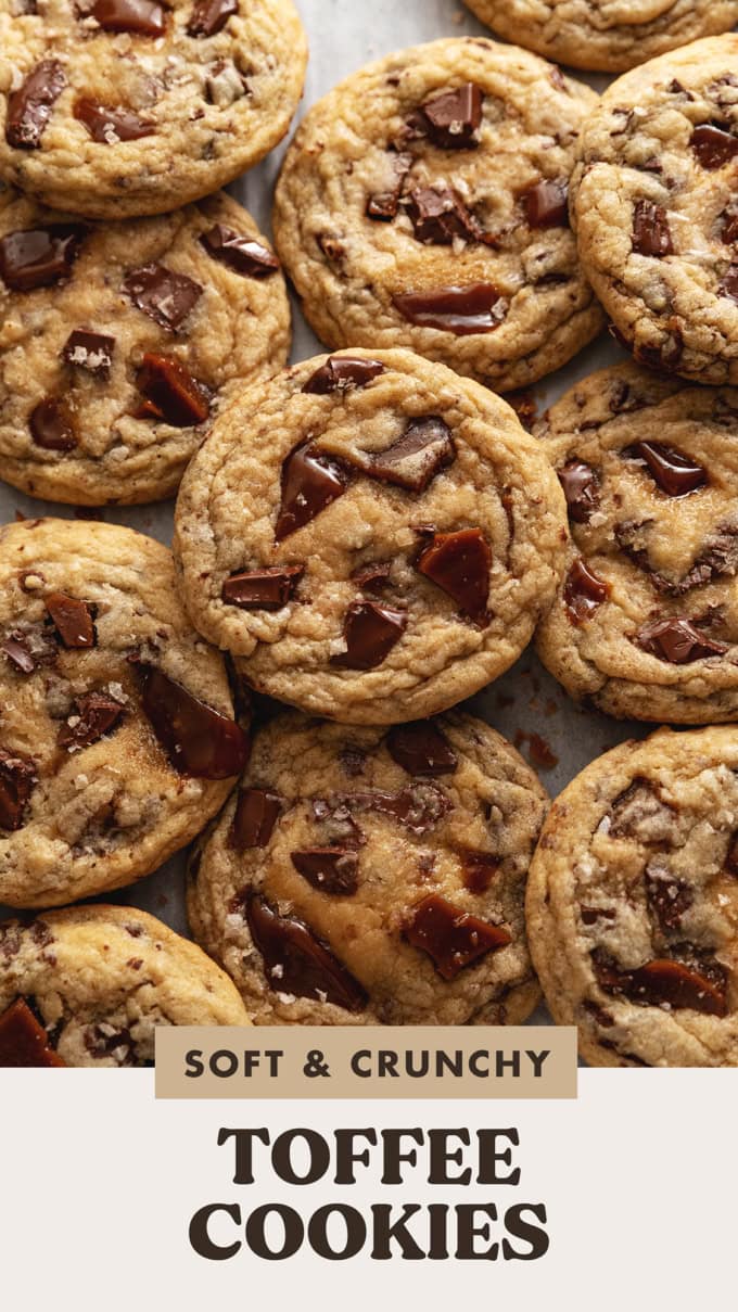 Several toffee cookies slightly overlapping on parchment paper.