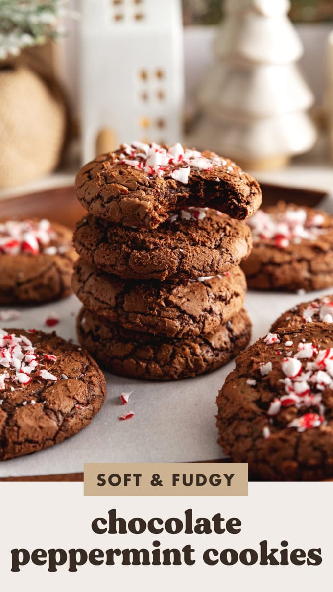 A stack of four chocolate peppermint cookies with a bite taken out of the one on top.
