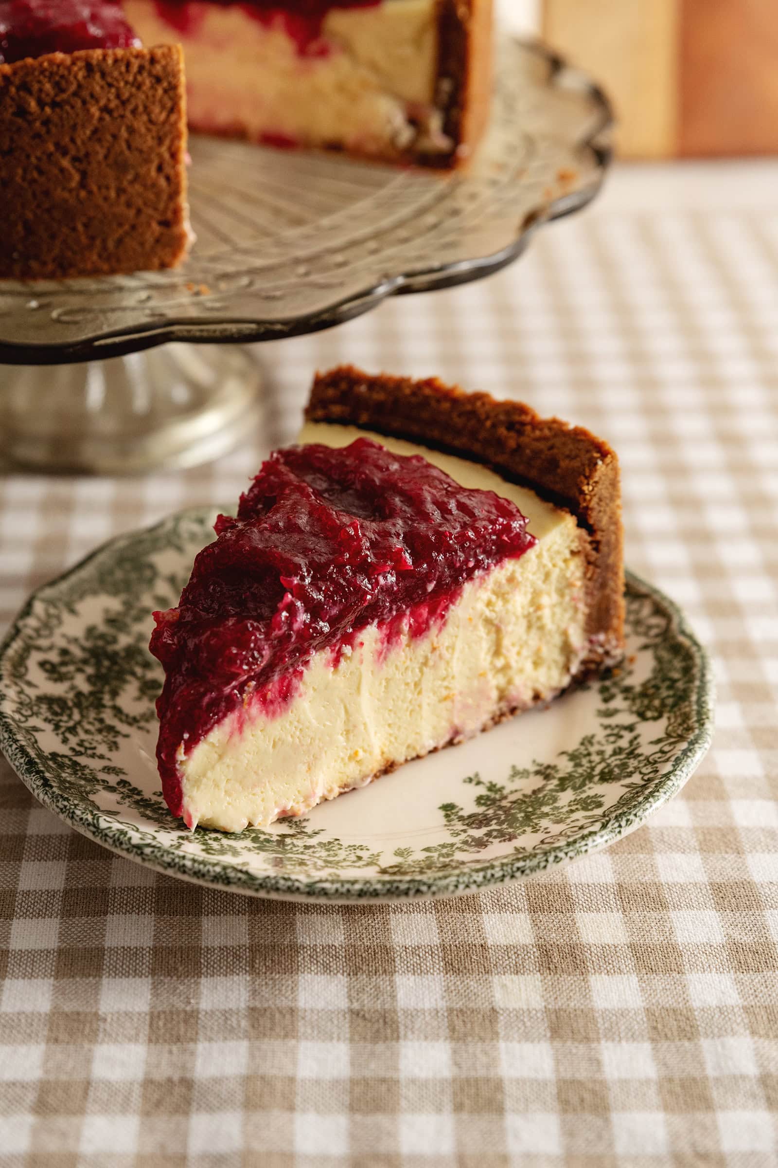 A slice of cranberry orange cheesecake on a plate.