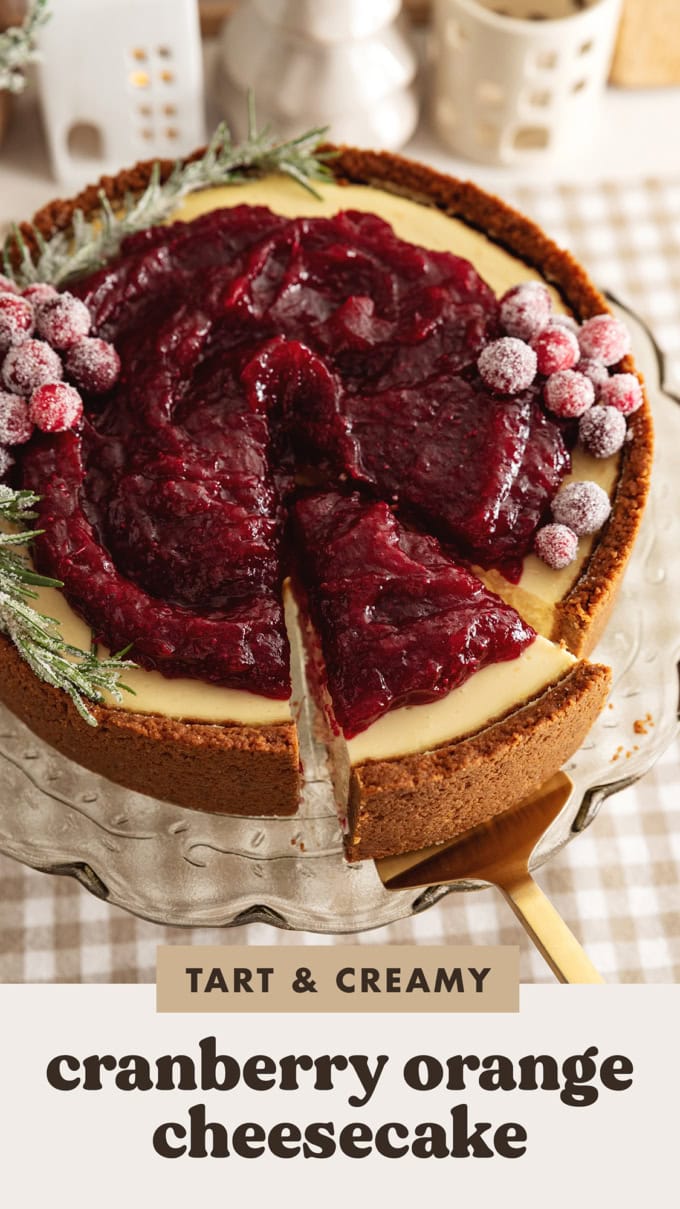 A cranberry orange cheesecake with a slice cut out of it and slightly pulled out from the rest of the cake.