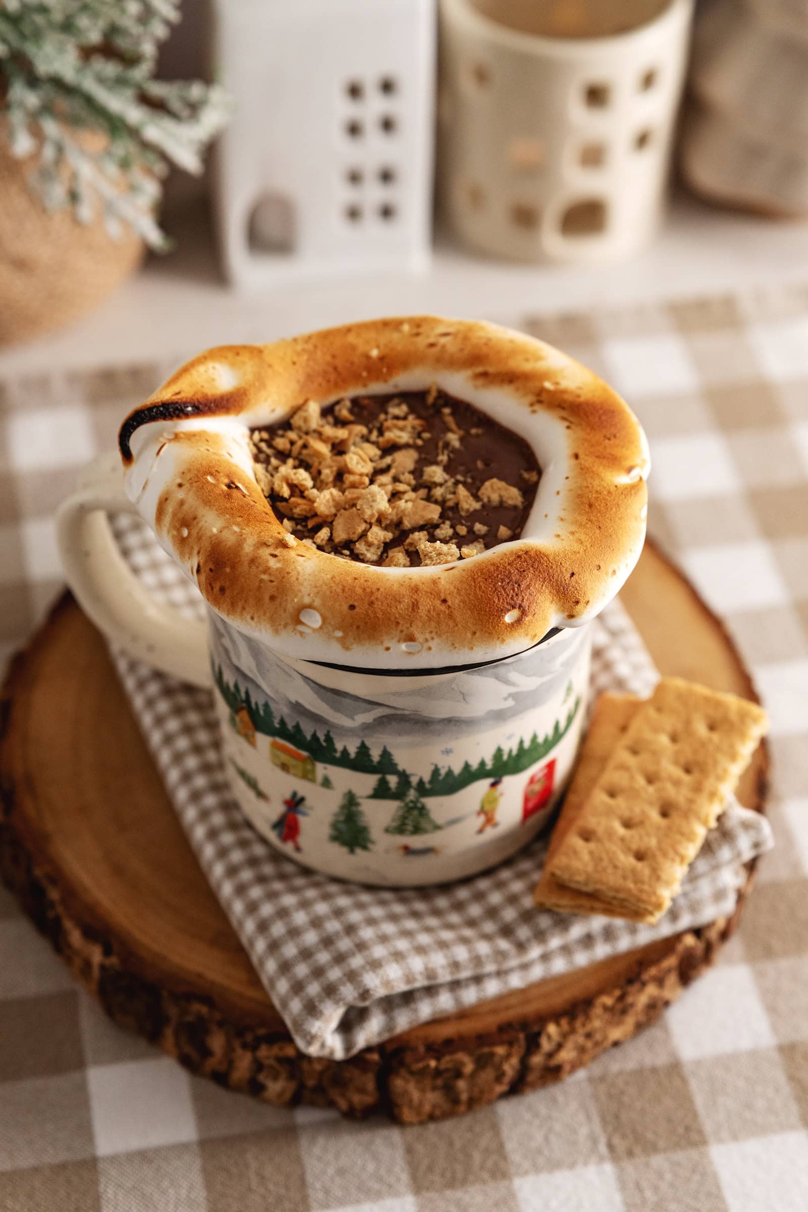 A mug of s'mores hot chocolate with toasted meringue around the rim of the mug.