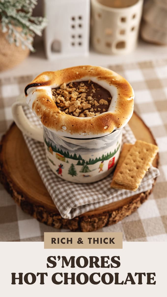 A mug of s'mores hot chocolate with toasted meringue around the rim of the mug.