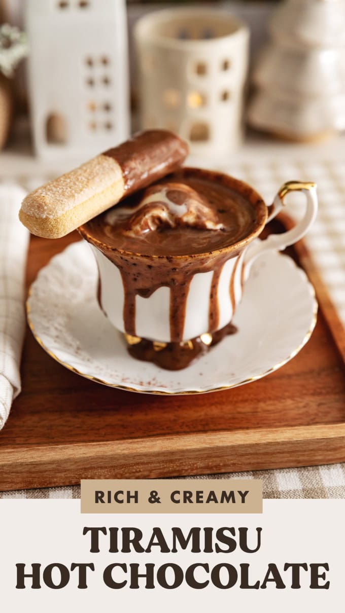 A teacup of tiramisu hot chocolate with hot chocolate running down the sides of the cup.